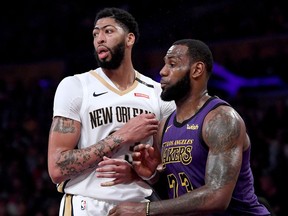 New Orleans Pelicans centre Anthony Davis (left) and the L.A. Lakers’ LeBron James guard each other during a December 2018 NBA game at the Staples Center in Los Angeles. The two are teammates after the announcement that three players and three first-round draft picks were traded to the Pelicans for Davis on June 15, 2019.