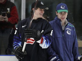 Jack Hughes, left, and his brother Quinn of the Vancouver Canucks take part in a Top Prospects Clinic on Thursday at Hillcrest Community Centre in Vancouver. Jack Hughes is expected to be the top pick in Friday's NHL Entry Draft at Rogers Arena.