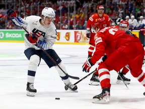 Yevgeni Kuznetsov of Russia tries to defend Jack Hughes of the United States, left, during the 2019 IIHF World Hockey Championship quarter-final game on May 23 at Ondrej Nepela Arena in Bratislava, Slovakia.