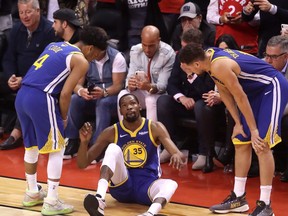 Kevin Durant of the Golden State Warriors reacts after sustaining an injury during the second quarter against the Toronto Raptors during Game Five of the 2019 NBA Finals at Scotiabank Arena on June 10, 2019 in Toronto.
