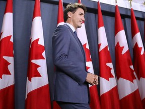 Prime Minister Justin Trudeau arrives at a news conference in Ottawa Tuesday on his government's decision to approve expansion of the Trans Mountain pipeline project.