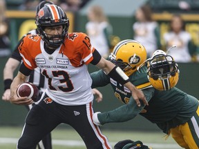 B.C. Lions quarterback Mike Reilly can't escape the aggressive tackling of Eskimos' defender Martese Jackson during Friday's CFL action in Edmonton. The Lions dropped their second straight game of the new season.