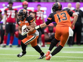 B.C. Lions quarterback Mike Reilly hands off the ball to John White IV during pre-season CFL action against the Calgary Stampeders at B.C. Place Stadium earlier this month. White had just four yards on four rushing attempts in last Saturday's season- and home-opener for the Lions, a 33-23 loss to Winnipeg.