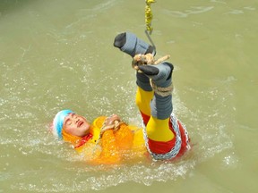 Chanchal Lahiri, a magician, is lowered into the Hooghly river as he performs one of his tricks in Kolkata, India, June 16, 2019.