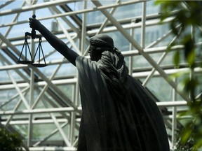 The Scales of Justice statue at B.C. Supreme Court in Vancouver. A man is alleging a principal sexually assaulted him during a school-sponsored camping trip in B.C.'s North Coast region.