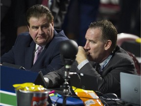 Vancouver Canucks' GM Jim Benning and AGM John Weisbrod discuss strategy Friday before the start of Round 1 of the 2019 NHL Entry Draft at Rogers Arena.