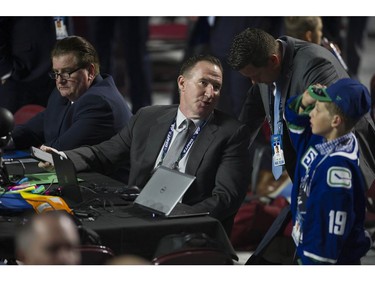 Vancouver Canucks GM Jim Benning and AGM John Weisbrod before the start of Round 1 of the 2019 NHL Draft at Rogers Arena, Friday, June 21.