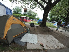 Campers at Oppenheimer Park as Mayor Kennedy Stewart provides a briefing following the release of 2019's Vancouver homeless count numbers.