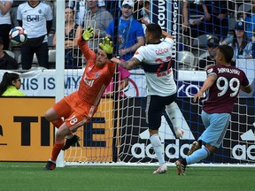 Then-Whitecaps goalkeeper Zac MacMath (left) and defender Erik Godoy defend against a shot by the Colorado Rapids during the first half at B.C. Place Stadium in June 2019. The 2-2 draw was the last time these two teams met.