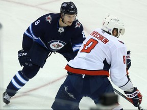 Winnipeg Jets defenceman Jacob Trouba (left) defends against Washington Capitals forward Alex Ovechkin in Winnipeg on Wed., Nov. 14, 2018. Kevin King/Winnipeg Sun/Postmedia Network