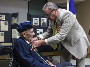 Bruno Burnichon of the French Consul in Winnipeg, on behalf of the French President, Emmanuel Macron, pins the Legion of Honour on Second World War Veteran Sir Ian Wilson at Deer Lodge Centre in Winnipeg on Saturday.