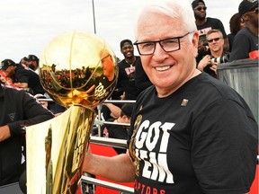 Director of sports science Alex McKechnie of the Toronto Raptors holds the Larry O'Brien Championship Trophy during the Toronto Raptors Championship victory parade on June 17, 2019.