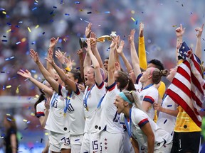 Megan Rapinoe of the USA lifts the FIFA Women's World Cup Trophy following her team's victory in the 2019 FIFA Women's World Cup France Final match between the United States and the Netherlands in Lyon, France.