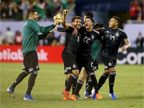 CHICAGO, ILLINOIS - JULY 07:  Jonathan dos Santos #6, Uriel Antuna #22, and Alexis Vega #14 of the Mexico celebrate after beating the United States 1-0 in the 2019 CONCACAF Gold Cup Final at Soldier Field on July 07, 2019 in Chicago, Illinois.