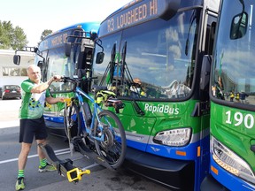 Coquitlam Mayor Richard Stewart loads his bicycle on to a new RapidBus.