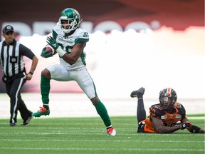 Loucheiz Purifoy of the Saskatchewan Roughriders, left, returns a kick for a touchdown as B.C. Lions' Crezdon Butler watches during the first half of Saturday's CFL game at B.C. Place Stadium in Vancouver.