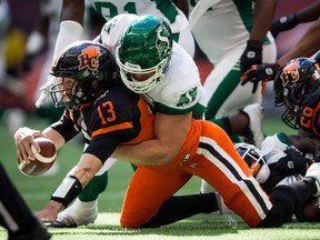 Saskatchewan Roughriders defensive tackle Zack Evans registers one of his team's four sacks against B.C. Lions quarterback Mike Reilly, 13, on Saturday.