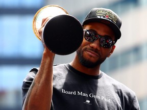 Kawhi Leonard holds the MVP trophy during the Toronto Raptors Victory Parade on June 17. The Toronto Raptors beat the Golden State Warriors 4-2 to win the NBA Finals.
