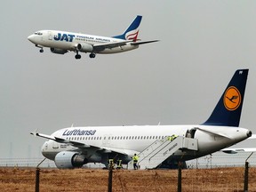 A Lufthansa Airbus A320 airplane, right, rests on the side of the runway after skidded off the tarmac at Belgrade Airport, Feb. 9, 2006. (ANDREJ ISAKOVIC/AFP/Getty Images)