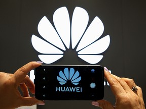 A Huawei logo is seen on a cell phone screen in their store at Vina del Mar, Chile July 18, 2019. (REUTERS/Rodrigo Garrido)
