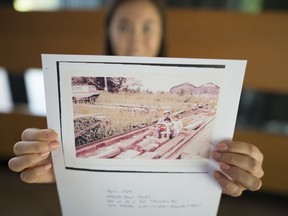 Ryanne Macdonald holds up a picture of her grandfather, Ryan Nakade, in Burnaby, on July 16, 2019.