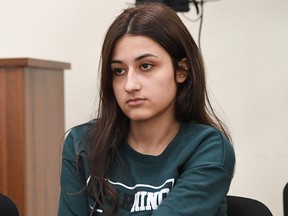Krestina Khachaturyan, one of three teenage sisters accused of murdering their father, attends a hearing at a court in Moscow on June 26, 2019. (YURI KADOBNOV/AFP/Getty Images)