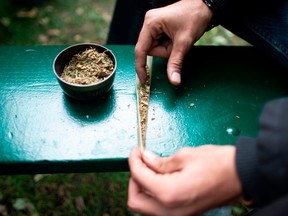 A man rolls a marijuana cigarette during a legalization party at Trinity Bellwoods Park in Toronto, Ontario, October 17, 2018.