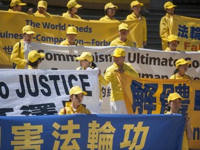 Falun Gong practitioners rally at the Vancouver Art Gallery before marching down Georgia Street in Vancouver.