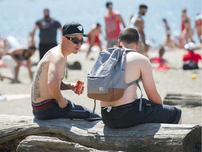 You still can't legally drink at the beach in no-fun Vancouver. Just don't tell anyone out drinking at the beach. A pilot project that would allow people to drink at English Bay and Kits Beach has been delayed. Photo: Arlen Redekop/Postmedia