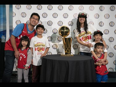 The Lin family poses for a photo with the Larry O'Brien NBA Championship Trophy at the B.C. Sports Hall of Fame in Vancouver on Tuesday, July 23.