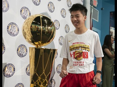 Teson Lui is all smiles while seeing the Larry O'Brien NBA Championship Trophy up close at the B.C. Sports Hall of Fame in Vancouver on Tuesday, July 23.