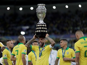 Brazil's Dani Alves celebrates with the trophy after his country won the Copa America tile with a 3-1 victory over Peru at Maracana Stadium in Rio de Janeiro, Brazi, on July 7, 2019.