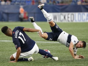 New England Revolution forward Juan Agudelo battles with Vancouver Whitecaps' defender Jake Nerwinski during the first half of Wednesday's Major League Soccer game at Gillette Stadium in Foxborough, Mass. The Whitecaps were tripped up 2-0 by the hosts.