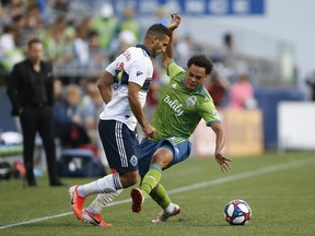 Seattle Sounders midfielder Henry Wingo tries to break up a pass by Vancouver Whitecaps defender Ali Adnan during the second half in Saturday's game at CenturyLink Field.