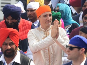Canadian Prime Minister Justin Trudeau (C) pays his respects at the Sikh Shrine Golden temple in Amritsar on February 21, 2018. Trudeau and his family are on a week-long official trip to India.