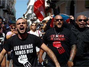 Men shout during ongoing protests calling for the resignation of Governor Ricardo Rossello in San Juan, Puerto Rico July 20, 2019. REUTERS/Marco Bello