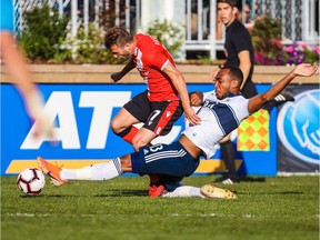 Cavalry FC attacker Nico Pasquotti (17) and Vancouver Whitecaps defender Derek Cornelius (13) battle for the ball during the first half during a Canadian Championship soccer match at Spruce Meadows. Mandatory Credit: Sergei Belski-USA TODAY Sports for CPL