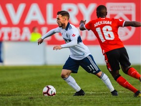 Vancouver Whitecaps midfielder Russell Teibert controls the ball in front of Cavalry FC midfielder Elijah Adekugbe (16) during the second half of the first leg of their Canadian Championship soccer match at Spruce Meadows. Photo: Sergei Belski-USA Today Sports