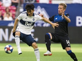 Vancouver Whitecaps #4 Hwang In-Beom keeps the ball from San Jose Earthquakes #14 Jackson Yueilli  in a regular season MLS soccer game at BC Place.