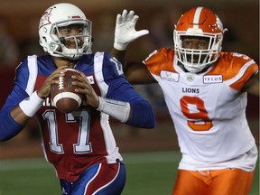 Montreal Alouettes quarterback Antonio Pipkin runs away from B.C. Lions's Shawn Lemon in Montreal on Friday September 14, 2018. Lemon was reacquired by the Lions on Monday in a trade with Toronto.