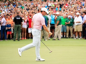 Rory McIlroy celebrates after winning the Tour Championship at East Lake Golf Club in Atlanta Sunday.