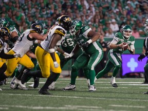 Saskatchewan Roughriders quarterback Cody Fajardo (7) carries the ball during a game against the Hamilton Tiger-Cats at Mosaic Stadium on Thursday