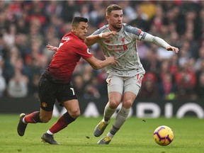 Manchester United's striker Alexis Sanchez, left, battles with Jordan Henderson of Liverpool during an English Premier League football match in Old Trafford on Feb. 24, 2019. Starting this season, Canadians will have to subscribe to DAZN to watch live EPL action.