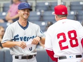 Everett AquaSox manager Louis Boyd, left, hands in his team's lineup before Friday's game against the Vancouver Canadians at Nat Bailey Stadium.