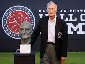 Former university and amateur football coach Frank Smith with the bust signifying his induction into the Canadian Football Hall of Fame in Hamilton during a Friday night ceremony.