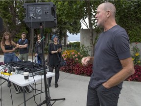 Chip Wilson talks to protesters in front of his Point Grey Road home on Saturday, where a 'Rave Against Renovictions' was held. Wilson made a surprise appearance and brief speech during the event.