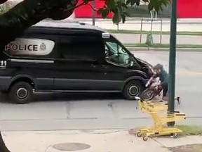 A cyclist is shown being struck by a Vancouver Police Department van on Great Northern Way.