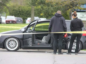 London police officers inspect a vehicle at the scene of a shooting at the corner of Trafalgar Street and Admiral Drive. Photo taken May 11, 2019.