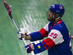 Travis Irving of the Maple Ridge Burrards takes a shot while wearing a jersey with an autism symbol on the sleeve.