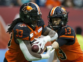 BC Lions QB  Mike Reilly hands off to Wayne Moore.